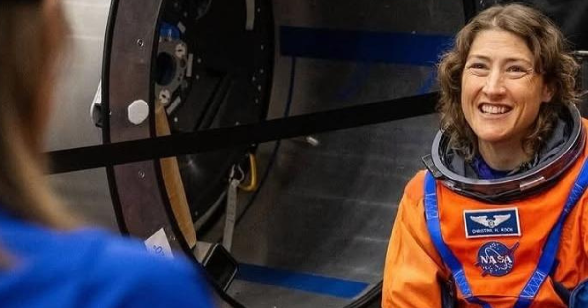 Christina Koch holding Ghanaian flag ahead of Artemis II mission