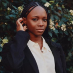 Yinka Ogunbiyi demonstrating HaloBraid, the world’s first braid assist robot designed to help professional hairstylists reduce braiding time.