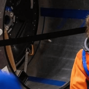 Christina Koch holding Ghanaian flag ahead of Artemis II mission